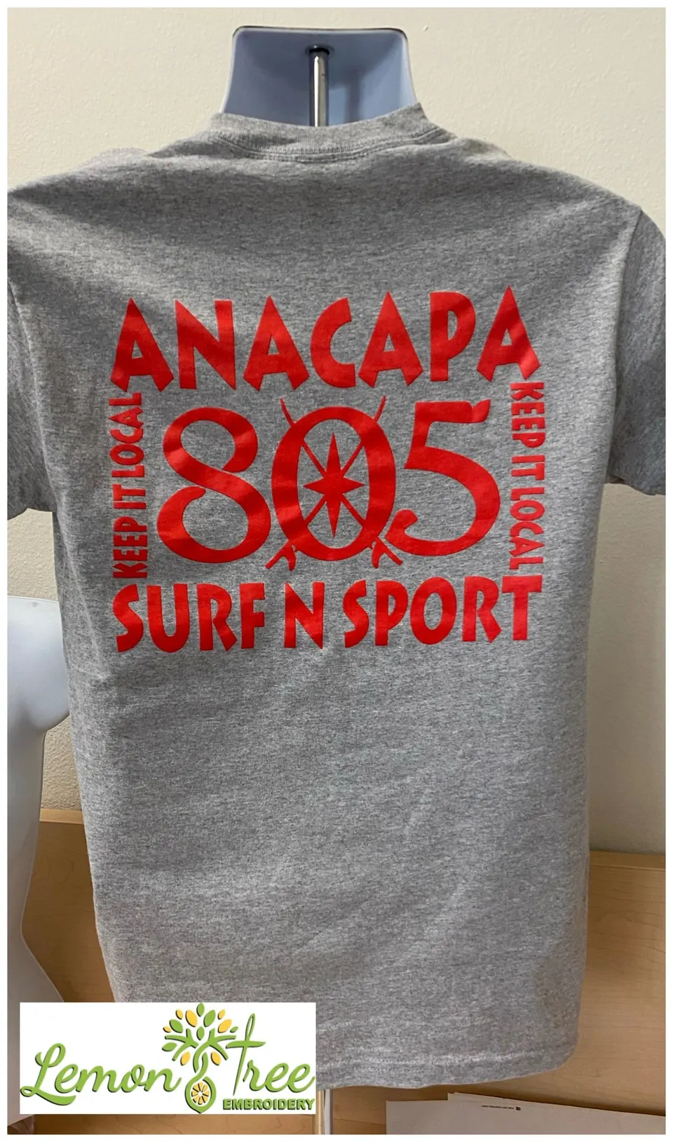 Gray tee printed with Anacapa 805 Surf N Sport in red