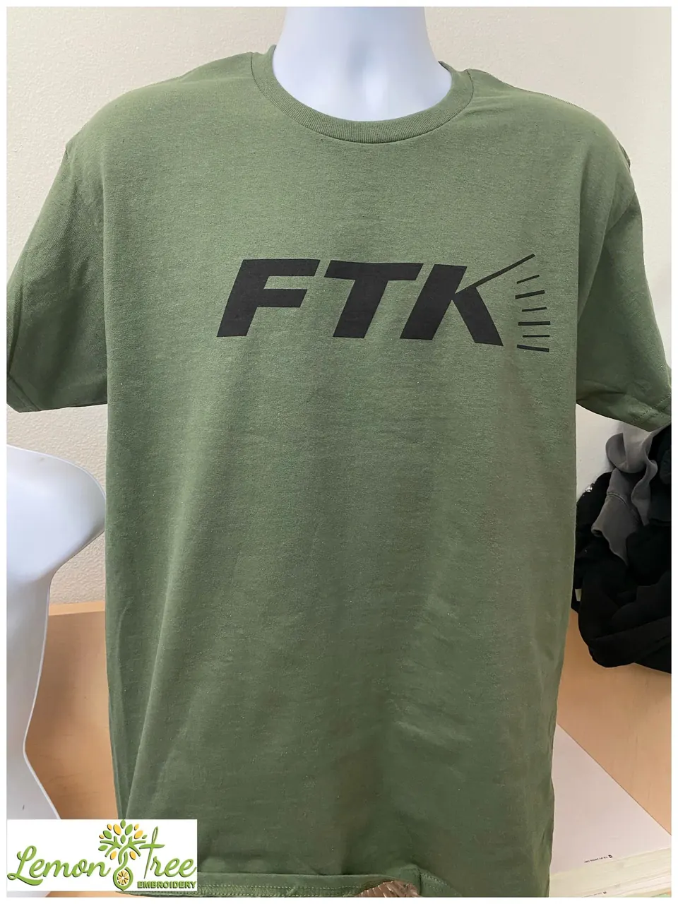 Olive tee printed with the FTK logo in black