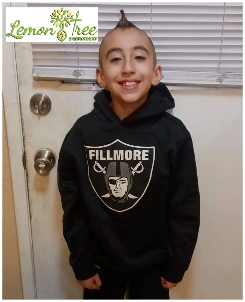 Smiling boy wearing a black Fillmore Raiders hoodie