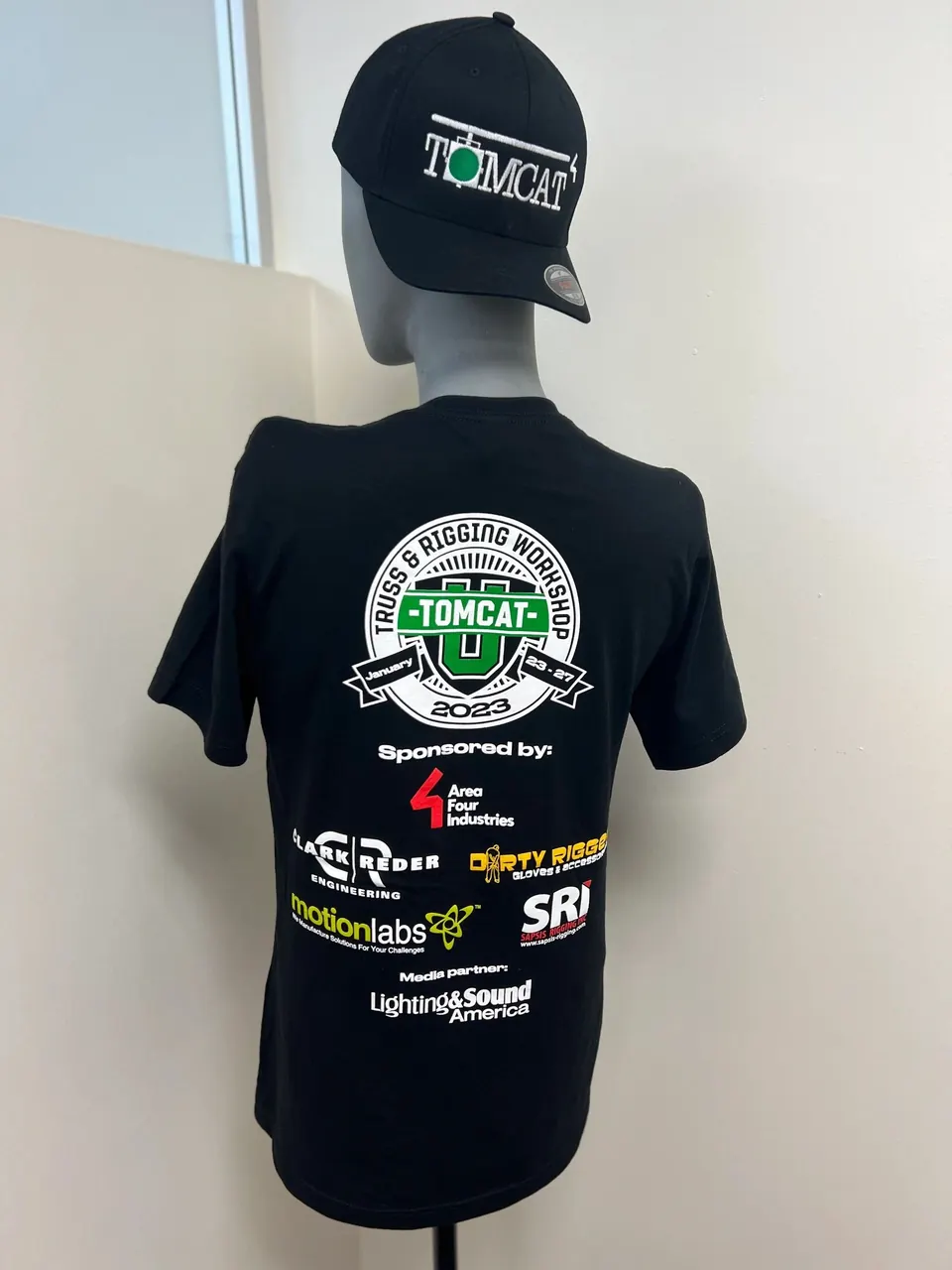 Black Tomcat 2023 event tee with sponsor logos and a matching hat on a mannequin