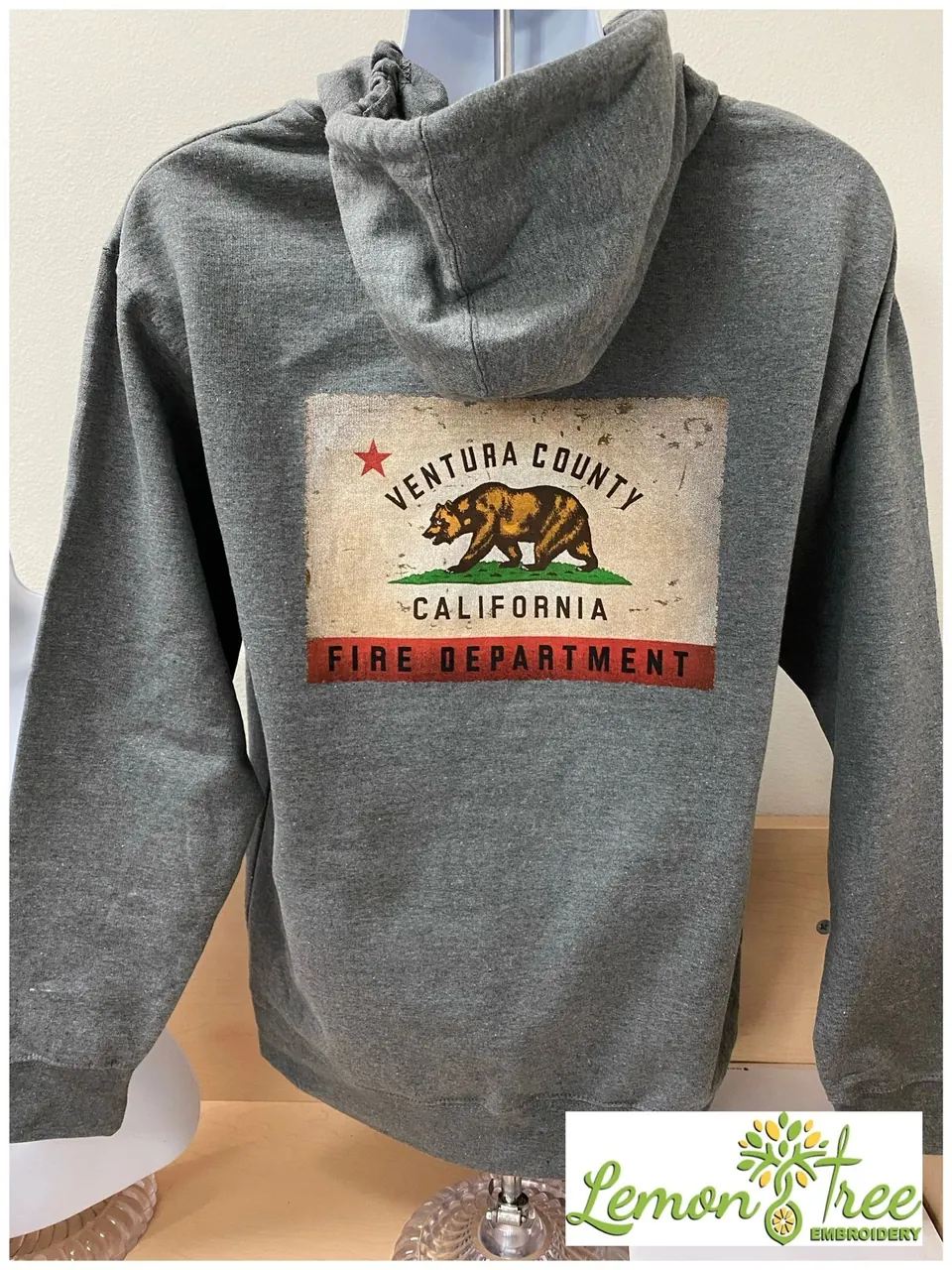Gray hoodie printed with a full color Ventura County California Fire Department bear flag